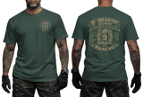 Man wearing forest green US Army 9th Infantry "Manchu" t-shirt, showcasing both front chest and detailed large back prints.