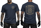 Man wearing navy US Army 9th Infantry "Manchu" t-shirt, showcasing both front chest and detailed large back prints.