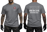 A man modeling a gray short-sleeve T-shirt shown from the front and back. The front has a small red, white, and black fire department style crest on the left chest with the word BERMUDA underneath.
