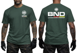 green tactical t-shirt featuring the BND eagle emblem and logo on the chest. The back shows a large BND print with the full Bundesnachrichtendienst name and German flag colors.