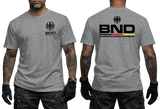 grey tactical t-shirt featuring the BND eagle emblem and logo on the chest. The back shows a large BND print with the full Bundesnachrichtendienst name and German flag colors.