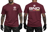 maroon tactical t-shirt featuring the BND eagle emblem and logo on the chest. The back shows a large BND print with the full Bundesnachrichtendienst name and German flag colors.