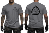 Charcoal gray t-shirt mockup with a gray Kali FMA martial arts graphic print. Features the tactical triangle emblem with a Philippine sun symbol on the front chest and back.
