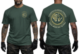 Two-view composite image of a dark green t-shirt featuring Polish Navy Special Forces JW Formoza graphics. The left side shows the front of the shirt with a small circular chest emblem. The right side shows the back of the shirt with a large circular crest featuring the unit's emblem and motto text. The shirt is displayed on a male model with tattooed arms and tactical gloves.