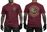 Two-view composite image of a maroon t-shirt featuring Polish Navy Special Forces JW Formoza graphics. The left side shows the front of the shirt with a small circular chest emblem. The right side shows the back of the shirt with a large circular crest featuring the unit's emblem and motto text. The shirt is displayed on a male model with tattooed arms and tactical gloves.