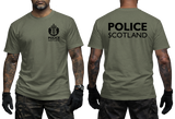 Front and back views of an olive green t-shirt worn by a model. The front features a black Police Scotland crest on the left chest, and the back features 'POLICE SCOTLAND' printed in large black letters across the upper back.
