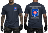 Front and back view of a navy t-shirt featuring the US Marine Corps Amphibious Raids Branch HRST Master logo. The front features a small unit shield insignia with a skull and stars on the left chest. The back displays a large version of the same insignia with 'AMPHIBIOUS RAIDS BRANCH' above it and 'HRST MASTER' below.