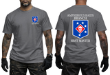Front and back view of a dark grey t-shirt featuring the US Marine Corps Amphibious Raids Branch HRST Master logo. The front features a small unit shield insignia with a skull and stars on the left chest. The back displays a large version of the same insignia with 'AMPHIBIOUS RAIDS BRANCH' above it and 'HRST MASTER' below.