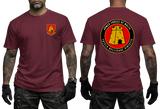 A man modeling a maroon short-sleeve t-shirt, showing both front and back views. The front features a small yellow and red military crest on the left chest.