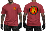 A red short-sleeve t-shirt shown on a model from both the front and back. The front features a small yellow and red military-style crest on the left chest.