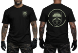 A black short-sleeve T-shirt shown on a model from the front and back. The front has a small olive-drab military crest on the left chest, and the back has a larger matching crest with the text 'SPECIAL OPERATIONS FORCES' and 'AUSTRIA JAGGKOMMANDO'.