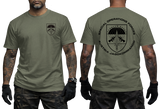 Front and back views of a man wearing an olive green t-shirt with black graphics. The front left chest features a small shield logo, while the back displays a large circular graphic with a parachute emblem and the text 'SPECIAL OPERATIONS FORCES' and 'AUSTRIA JAGOKOMMANDAO'.