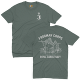 Two-view composite image of a dark green t-shirt featuring Royal Danish Navy Frogman Corps (Frømandskorpset) graphics. The top view shows the front of the shirt with a small anchor, shield, and crown chest emblem and 'Frømandskorpset' text. The bottom view shows the back of the shirt with a large graphic of frogman commandos wading through water with rifles, 'Frogman Corps' heading, and 'Royal Danish Navy' text at the bottom.