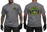 A gray short-sleeve t-shirt shown on a model from the front and back. The front features a small circular green and yellow emblem on the left chest.