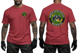 A red short-sleeve t-shirt shown on a model from both the front and back. The front features a small circular green and yellow logo on the left chest.