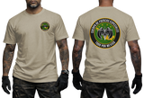 A man modeling a beige short-sleeve t-shirt, showing both the front and back views. The front features a small circular green and yellow emblem on the left chest.
