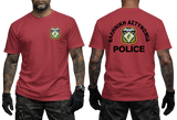 A red short-sleeve t-shirt shown on a model from both the front and back. The front features a small crest on the left chest, and the back features a large crest in the center with the text 'ΕΛΛΗΝΙΚΗ ΑΣΤΥΝΟΜΙΑ POLICE' in black.