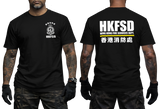 A black short-sleeve t-shirt shown on a model from both the front and back. The front features a white HKFSD emblem on the left chest, and the back features large white 'HKFSD' text with 'HUANG KONG FIRE SERVICES DEPT.
