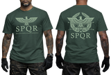 Two-view composite image of a forest green t-shirt featuring Roman-inspired SPQR graphics. The left side shows the front of the shirt with a small emblem. The right side shows the back of the shirt with a large imperial eagle graphic and 'SPQR' text. The shirt is displayed on a male model with tattooed arms and tactical gloves. 