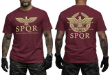 Two-view composite image of a maroon t-shirt featuring Roman-inspired SPQR graphics. The left side shows the front of the shirt with a small emblem. The right side shows the back of the shirt with a large imperial eagle graphic and 'SPQR' text. The shirt is displayed on a male model with tattooed arms and tactical gloves.