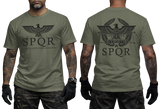 Two-view composite image of a military green t-shirt featuring Roman-inspired SPQR graphics. The left side shows the front of the shirt with a small emblem. The right side shows the back of the shirt with a large imperial eagle graphic and 'SPQR' text. The shirt is displayed on a male model with tattooed arms and tactical gloves.