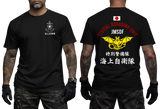 Two-view composite image of a black tactical t-shirt. The left side shows the front with a small white chest emblem featuring an anchor, cherry blossom, and Japanese text. The right side shows the back with a Japanese flag, red and white 'SPECIAL BOARDING UNIT JMSDF' text, and a large yellow winged bat/anchor emblem over white Japanese kanji.