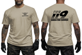 Front and back view of a tattooed male model wearing a tactical Sand tan t-shirt. The left chest features a small black winged "KOREA FIRE SERVICE" emblem. The back showcases a large black "119" graphic with Korean Hangeul text "구조대" above it and "KOREA FIRE SERVICE" printed below.