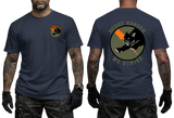 A man modeling a navy blue t-shirt, showing both the front and back views. The front features a small circular 'Special Forces' patch on the left chest, while the back displays a large graphic with a black scout rhino, an orange chevron, and the text 'SCOUT RANGER WE STRIKE'.