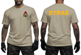 A man modeling a beige short-sleeve T-shirt shown from the front and back. The front has a small multicolor firefighter-style crest on the left chest, and the back has the word "STRAZ" printed in large yellow letters.