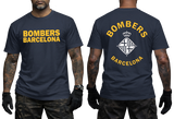 A man modeling a navy blue t-shirt with yellow and white graphics. The front view shows 'BOMBERS BARCELONA' in yellow text, and the back view shows a large white and yellow bomber-style crest with the words 'BOMBERS BARCELONA'.