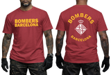 A red short-sleeve t-shirt with yellow 'BOMBERS BARCELONA' text on the front and a white 'BOMBERS BARCELONA' crest on the back, modeled on a man against a white background.