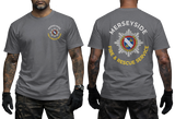 A man modeling a gray short-sleeve t-shirt, showing both the front and back views. The front features a small circular chest graphic for the Merseyside Fire & Rescue Service.