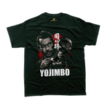 A front view of a green t-shirt featuring a detailed, vintage-style graphic montage inspired by the film 'Yojimbo'. The design includes three distressed, black and white portraits of Japanese actor Toshiro Mifune in samurai attire, layered over a large, blood-splattered red circle background resembling the Japanese flag. Bold white text at the bottom reads 'YOJIMBO'. White Japanese Kanji characters are placed vertically to the right of the central figure. 